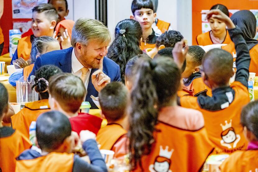 De koning aan tafel met allerlei kinderen